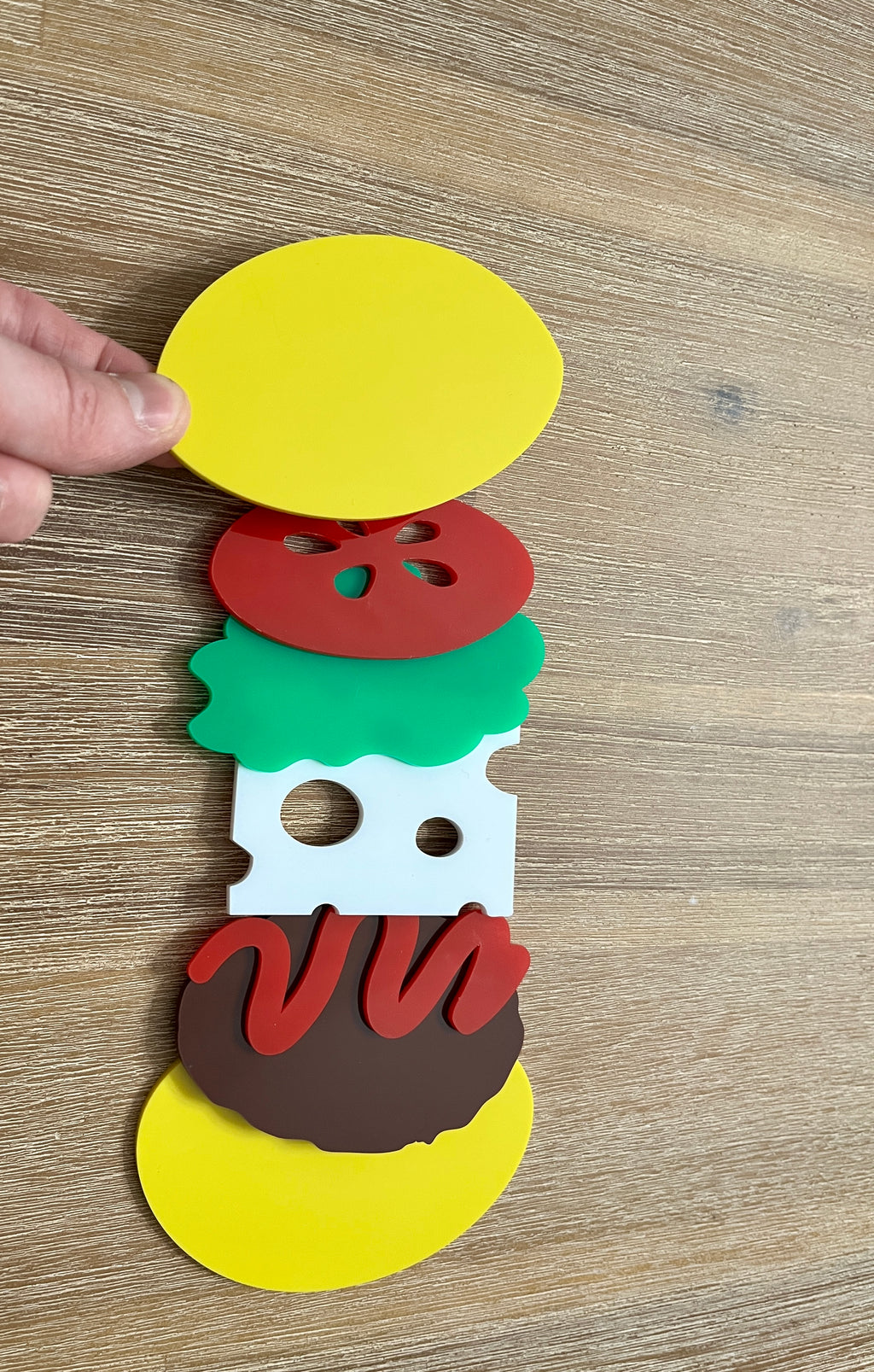 Little Dry Erasables - Burger 7 Piece Set featuring handcrafted wooden play pieces of bun halves, tomato slice, lettuce leaf, slice of cheese with holes, burger patty, and ketchup swirl for homeschool education resources.