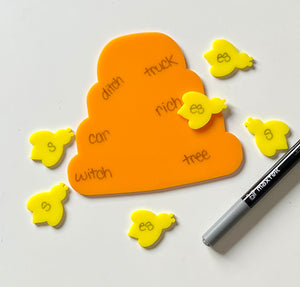 Yellow and orange bee and hive dry erase educational tools on a white background