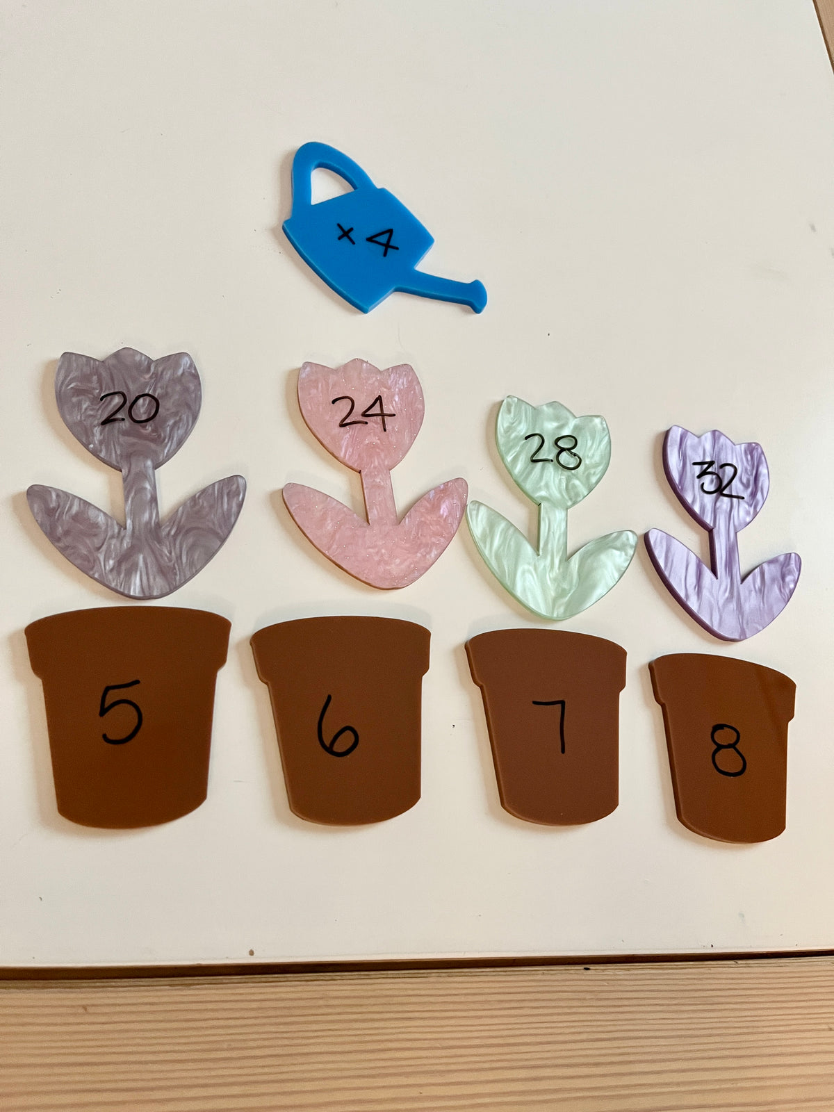 Little Dry Erasables - Marble Flowers with Brown Pots and Watering Can featuring pastel marbled flower shapes with multiplication facts, brown pots numbered 5 to 8, and a blue watering can, handcrafted homeschool education resources.