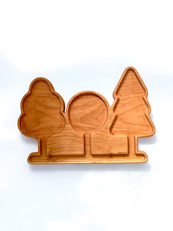Light brown wooden serving tray with three tree-shaped compartments on a white background