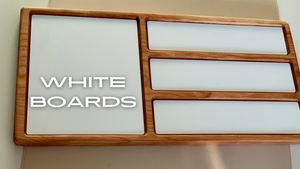 Wooden-framed organizer holding five whiteboard panels of varying sizes on a beige surface