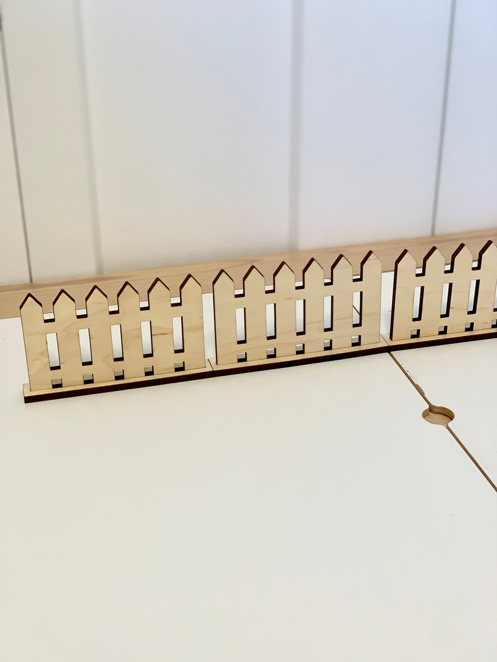 Small wooden freestanding play fences in natural wood color on white surface for imaginative play