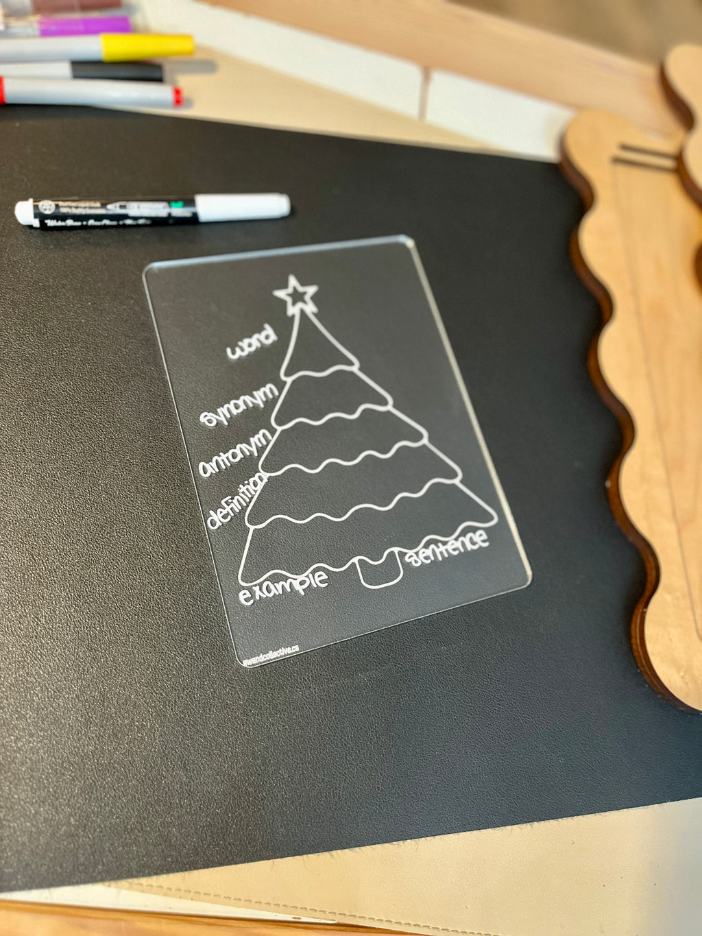 Transparent learning board shaped like a Christmas tree with vocabulary labels word, antonym, synonym, definition, example, sentence