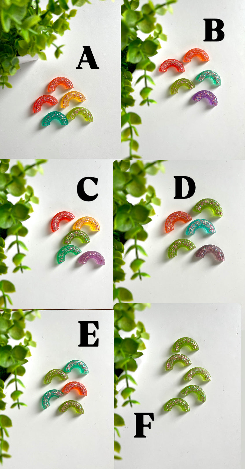 Groups of five or six translucent glittery rainbow-shaped resin pieces in various colors on a white surface near green plant leaves