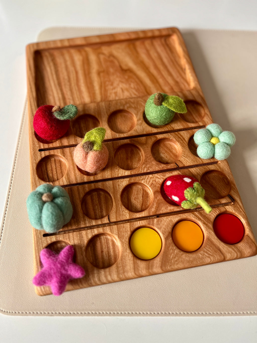Wooden 20 Twenty Frame Sensory Tray with felt fruit shapes and colorful painted circles on natural wood background