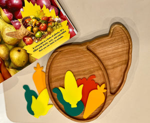 Smooth wooden tray shaped like a cornucopia with colorful foam fruits and vegetables on a beige surface