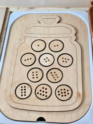 Wooden cookie jar-shaped Flisat insert with ten numbered cookie slots featuring 1-10 chocolate chip holes on light wood background
