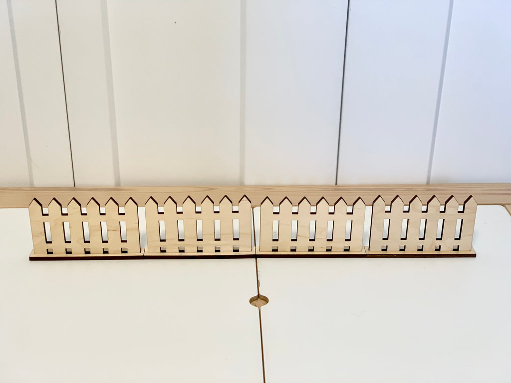 Wooden freestanding play fences with picket design on white surface for imaginative and sensory play
