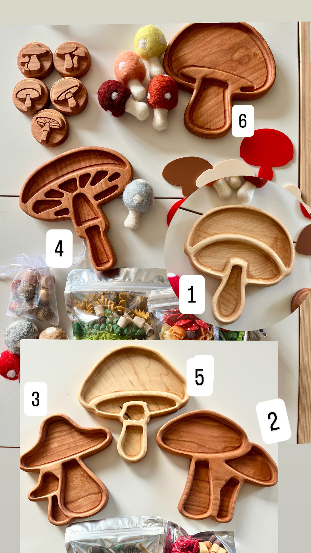 Various wooden trays shaped like mushrooms alongside felt mushroom toys and bags of colorful pasta on white surface
