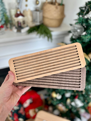 Hand holding two wooden slotted trays in natural and dark walnut tones designed as Dark Walnut Wood Slotted Acrylic Insert & Flash Card Holder / Story Board fits into Large Flisat Table Top Insert, handcrafted homeschool education resources.