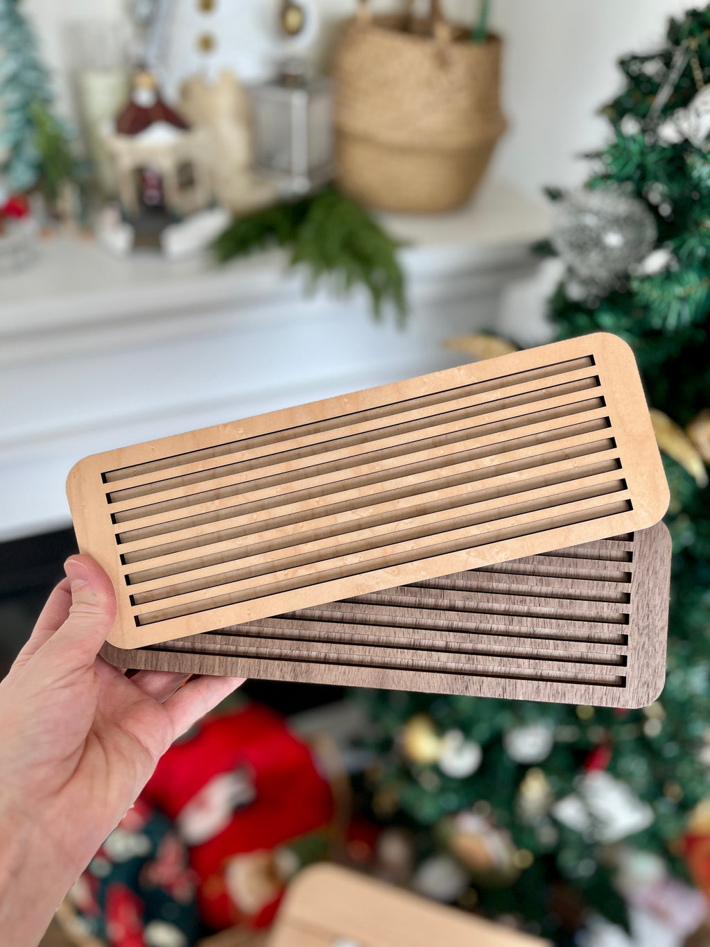 Hand holding two wooden slotted trays in natural and dark walnut tones designed as Dark Walnut Wood Slotted Acrylic Insert & Flash Card Holder / Story Board fits into Large Flisat Table Top Insert, handcrafted homeschool education resources.