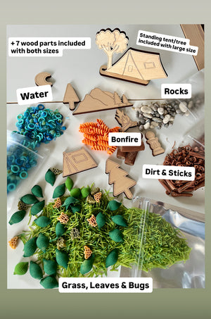 Wooden camping shapes and nature-themed sensory play items including blue rings, orange spirals, green leaves, and small rocks on white surface