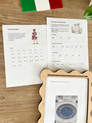 Digital Download | Roman Numerals, Their History & DeCoding Activity showing printed decoding worksheets featuring Roman numeral puzzles, historical imagery, and a wooden tray on a wood surface with an Italian flag and green plant, handcrafted homeschool education resources.