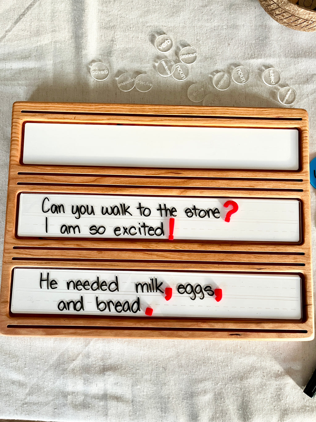 Little Dry Erasables - Mini Punctuation and Loose Parts 26 Pieces showing handcrafted wooden trays with writable white panels featuring handwritten sentences and colorful punctuation marks, handcrafted homeschool educational resources.