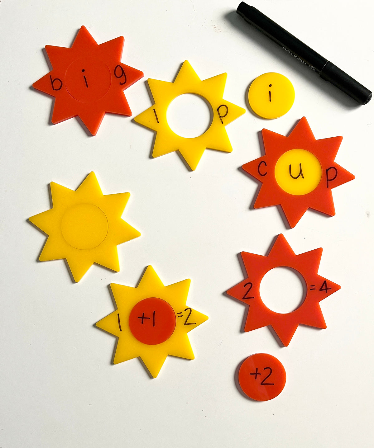 Little Dry Erasables - Sunshines 2 Part showing bright yellow and orange sun-shaped pieces and round inserts with letters and numbers, black dry-erase marker, handcrafted homeschool education resources.