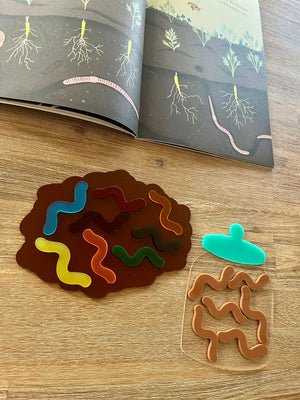 Little Dry Erasables - Worms with Dirt or Jar featuring colorful translucent worm shapes on a brown dirt-shaped tray and a clear jar piece on a wood surface, handcrafted homeschool education resources.