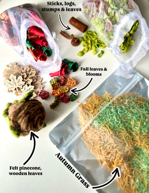 Assorted autumn craft supplies including felt pinecone, wooden leaves, colored pasta leaves and blooms, sticks, and green and orange dried grass