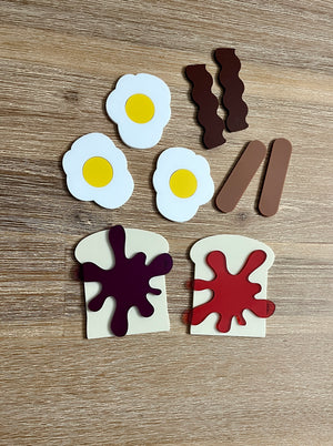 Little Dry Erasables - Breakfast Toast with Jam, Bacon, Sausage and Eggs featuring handcrafted wooden play pieces of fried eggs, bacon strips, sausage links, and toast with vibrant jam spots for homeschool education resources.