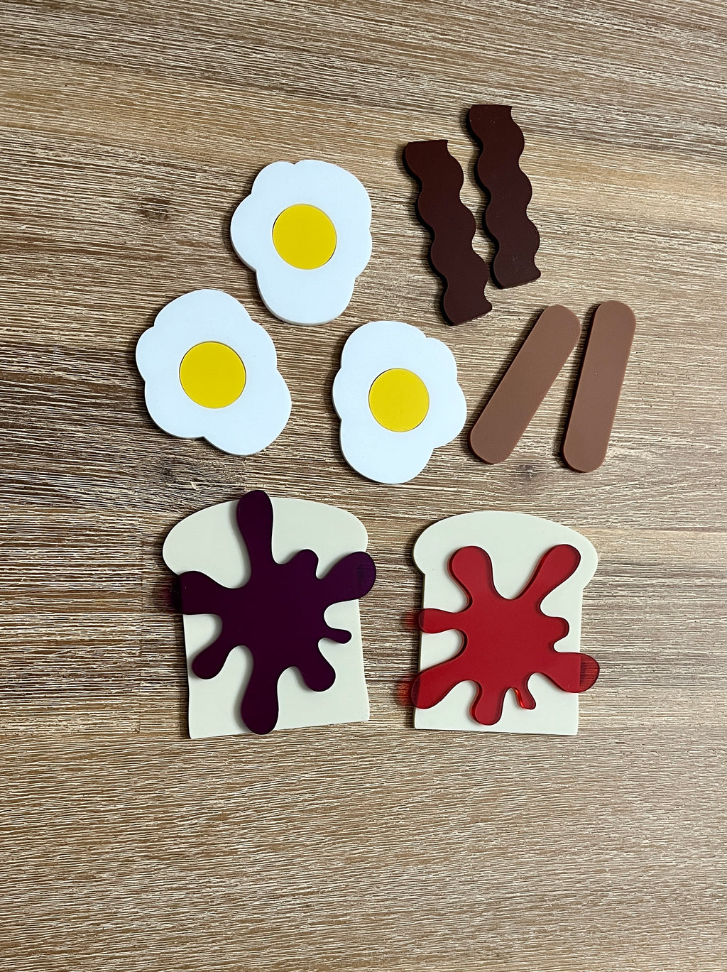 Little Dry Erasables - Breakfast Toast with Jam, Bacon, Sausage and Eggs featuring handcrafted wooden play pieces of fried eggs, bacon strips, sausage links, and toast with vibrant jam spots for homeschool education resources.