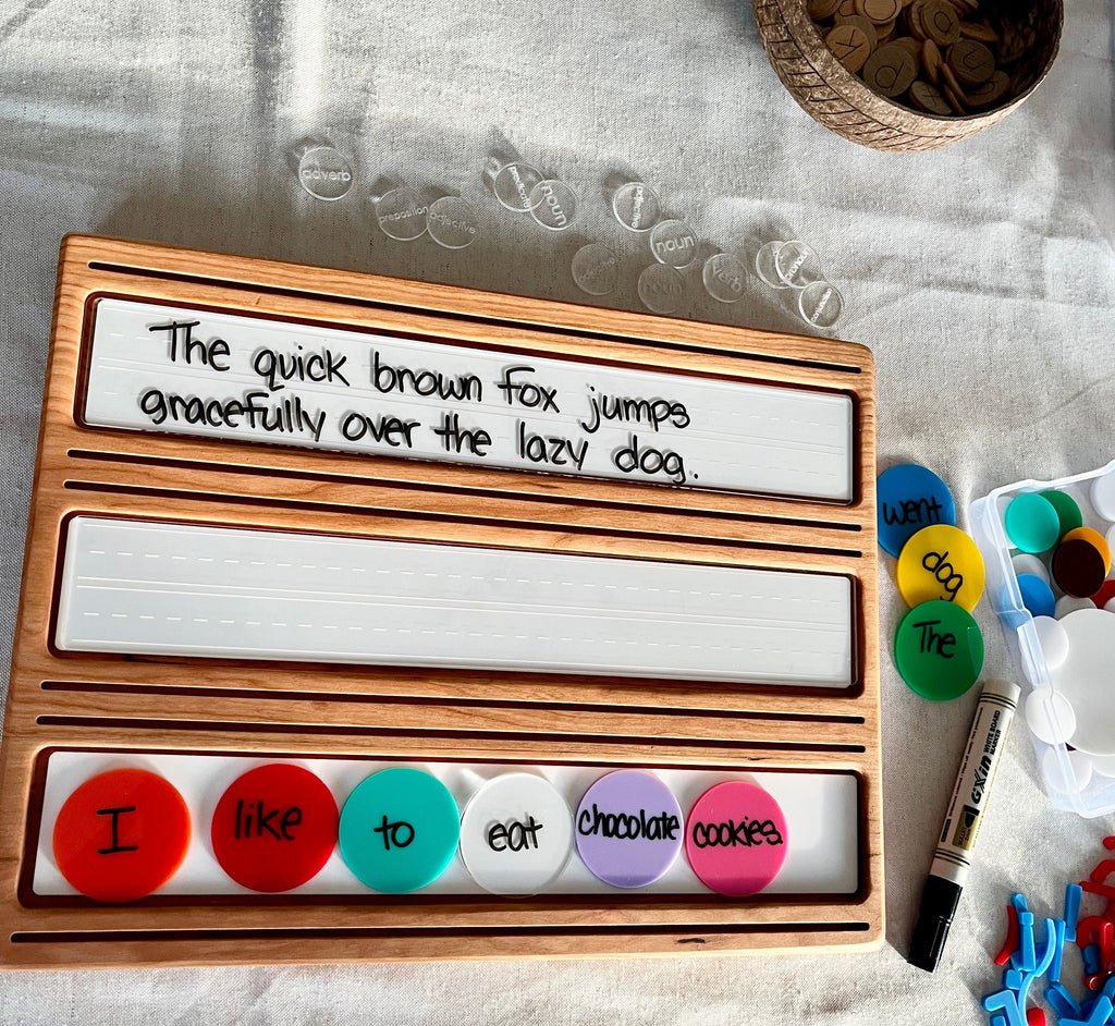 Wooden Sentence & Learning Tray | Open Ended Literacy Board | Math & Play showing handcrafted wood tray with dry-erase panel featuring handwritten sentence, colorful word tokens, marker, and homeschool educational resources.