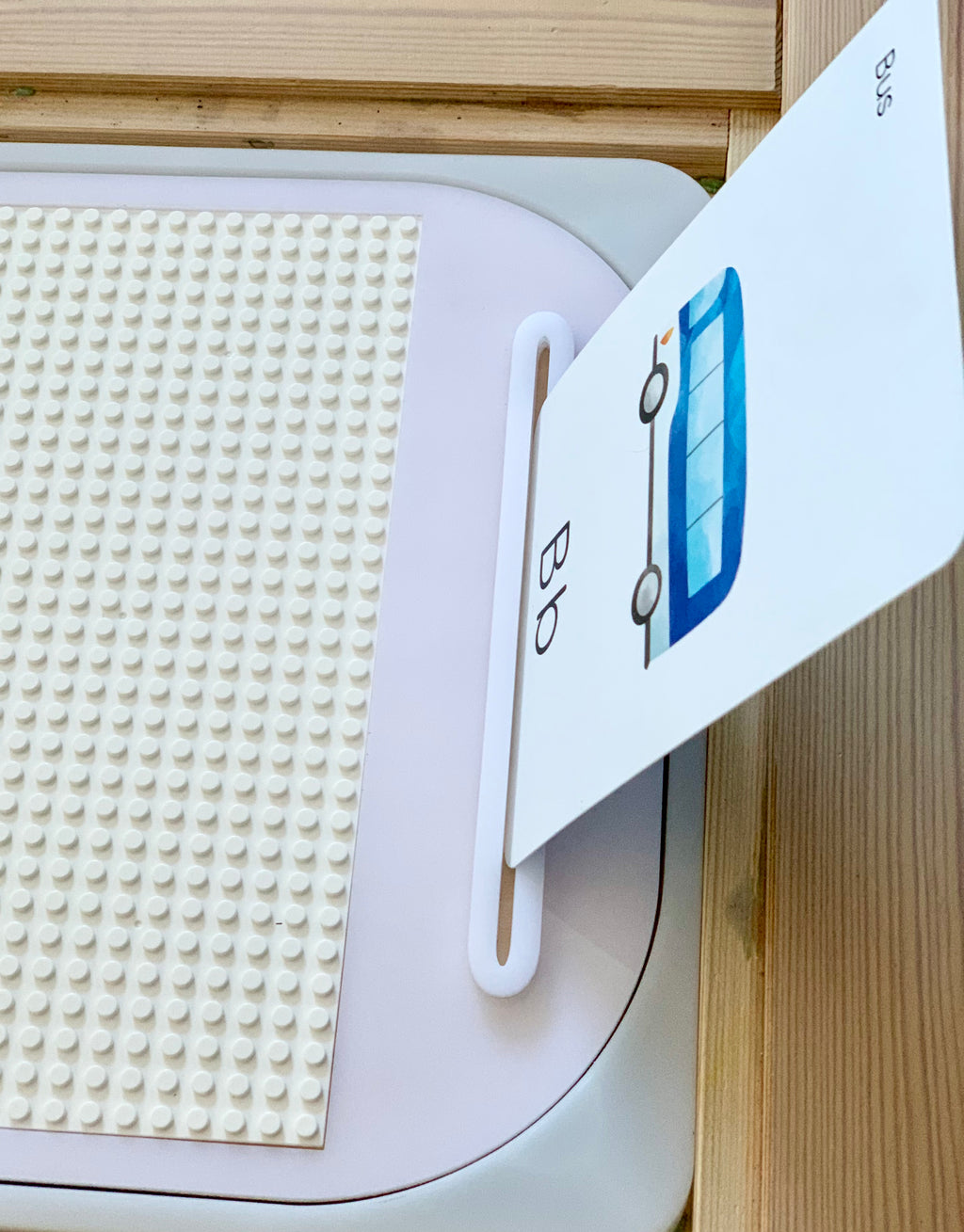 White acrylic Flisat tabletop insert with Lego base and card holder showing letter B flashcard on wood surface