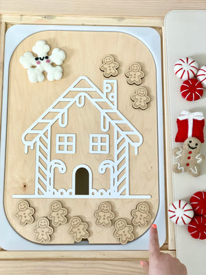 Maple wood gingerbread house Flisat insert with white acrylic roof and ten small wooden gingerbread people on table