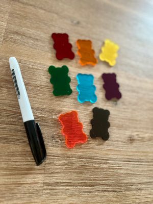 Little Dry Erasables — Gummy Bears featuring translucent colorful gummy bear shapes in various shades arranged on a wooden surface with a black marker, handcrafted homeschool education resources.