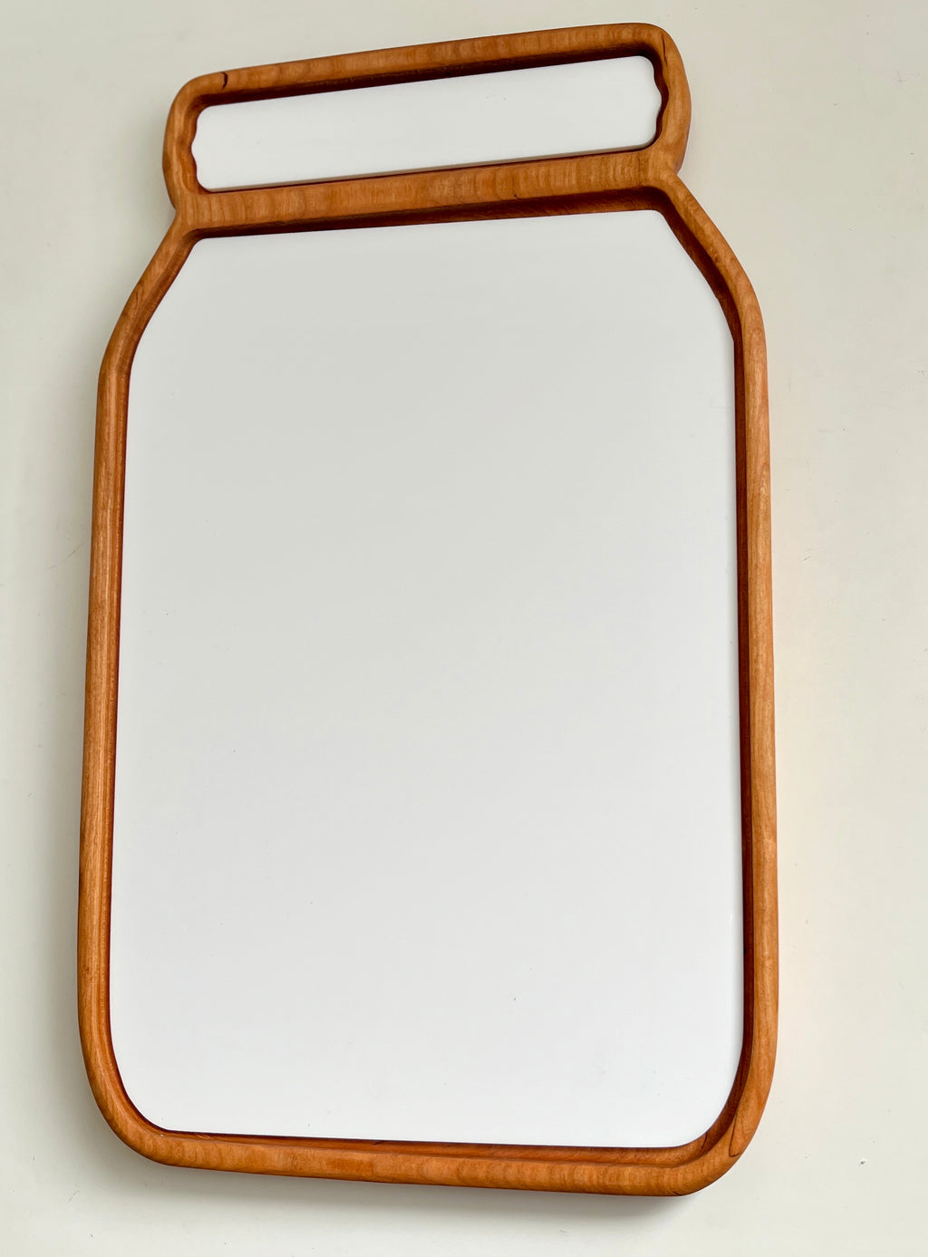 Wooden tray with smooth rounded edges and handle, natural light wood frame with white flat surface inside