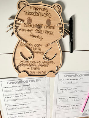 Laser Cut Groundhog Tray with Dry Erase Insert shaped like a groundhog with handwritten educational facts, alongside completed groundhog trivia worksheets and black dry erase marker, handcrafted homeschool education resources.