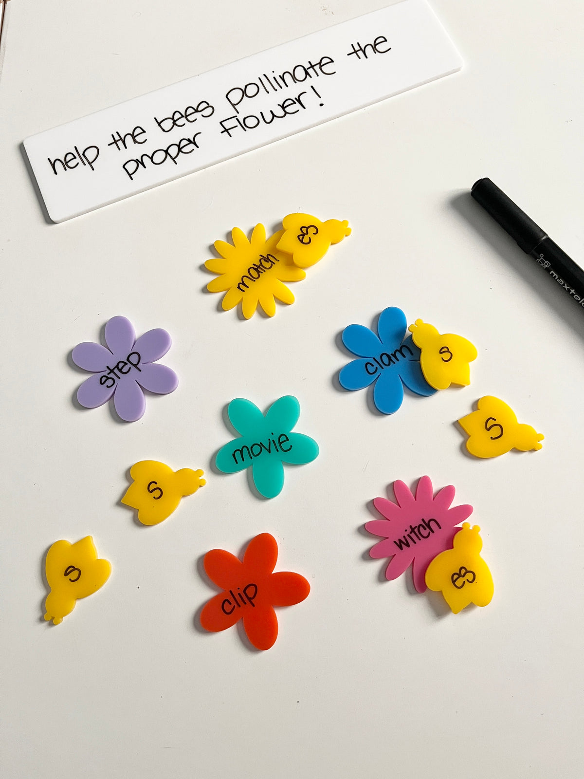 Little Dry Erasables - Pollinators - Bees & Flowers showing colorful flower shapes paired with yellow bee cutouts labeled with word parts and a dry erase marker on a white surface, handcrafted homeschool education resources.
