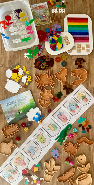 Seasonal homeschool setup featuring wood trays shaped like animals and plants, colorful felt pieces, educational sorting games, storybooks, and STEM Insert – Acrylic Insert with Different Peg Options - Neighborhood, Veggie Garden, Flower Garden, Under the Sea + More, handcrafted homeschool education resources.