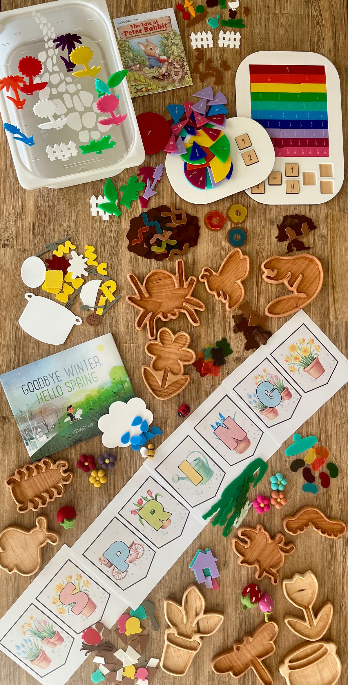 Seasonal homeschool setup featuring wood trays shaped like animals and plants, colorful felt pieces, educational sorting games, storybooks, and STEM Insert – Acrylic Insert with Different Peg Options - Neighborhood, Veggie Garden, Flower Garden, Under the Sea + More, handcrafted homeschool education resources.