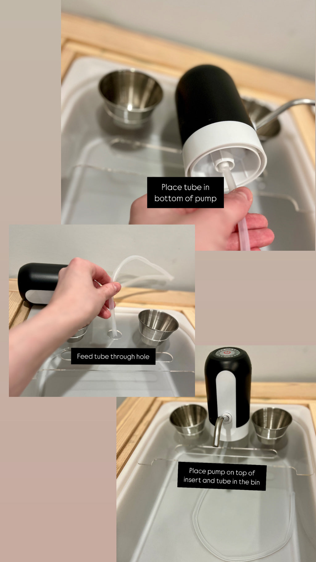 Black and white play kitchen water pump with clear tube installed on wooden sink insert with metal bowls