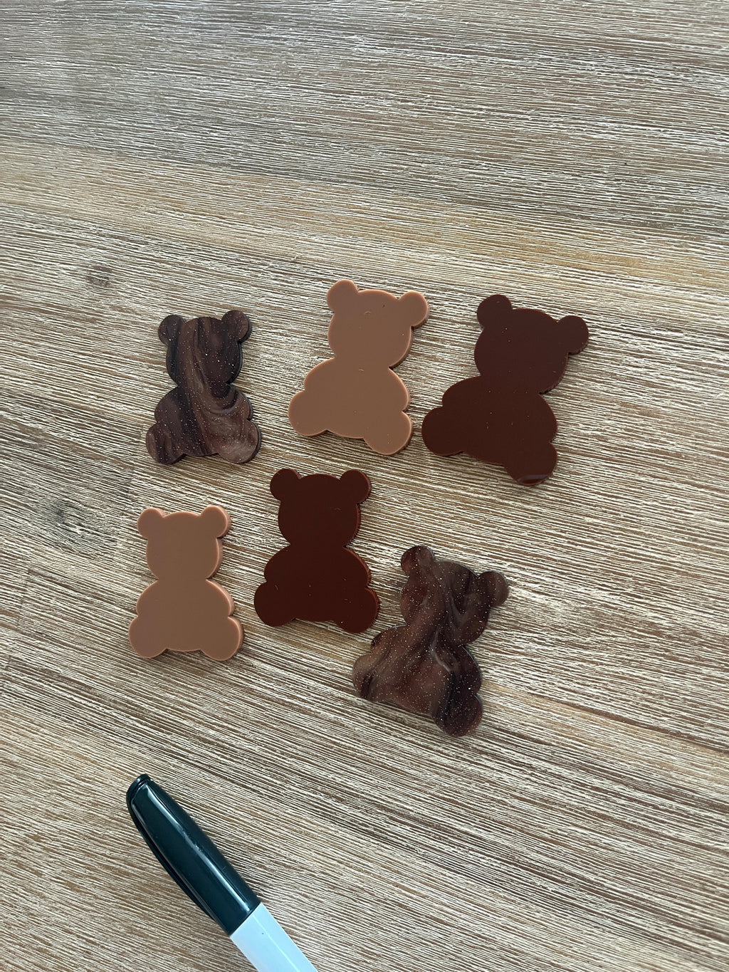 Little Dry Erasables — Teddy Bears featuring six wooden bear shapes in various brown tones arranged on a wood surface with a black marker, handcrafted homeschool education resources.