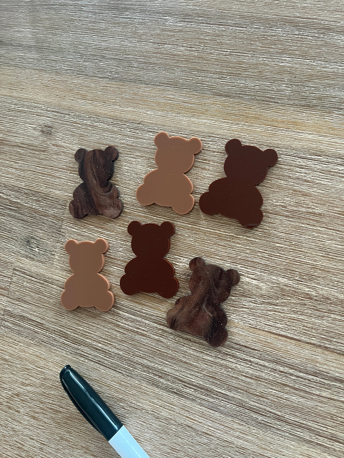 Little Dry Erasables — Teddy Bears featuring six wooden bear shapes in various brown tones arranged on a wood surface with a black marker, handcrafted homeschool education resources.