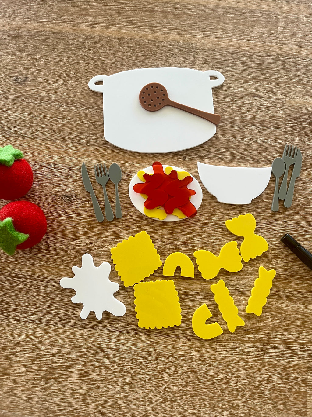 Little Dry Erasables - Pasta with Sauce, Pot, Plate, Bowl and Cutlery featuring handcrafted wooden pasta shapes, sauce splatters, cooking pot, utensils, and sensory strawberries for homeschool education resources.