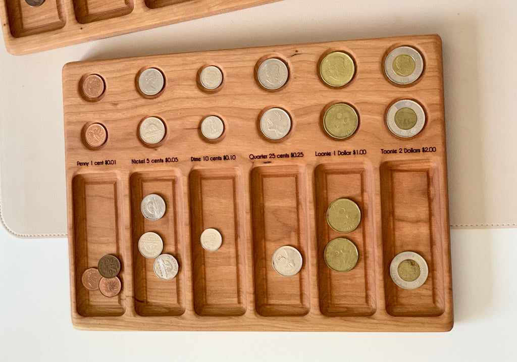 Wooden coin sorting tray with labeled slots containing U.S. pennies, nickels, dimes, quarters, loonies, and toonies