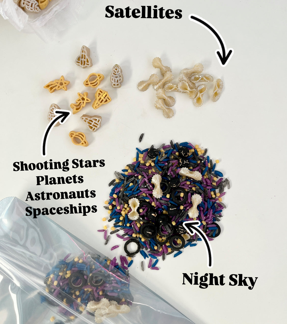 Space-themed pasta shapes including planets, stars, astronauts, and spaceships with mixed colored rice sensory set