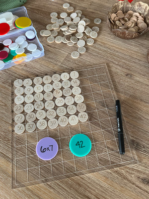 Dry Erasable Blank Open Ended 100 Frame Hundred Board showing translucent grid board with wooden number discs arranged in numerical order, colorful counters, black dry erase marker, handcrafted homeschool education resources.
