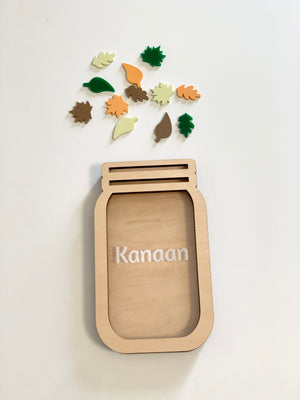 Personalized wooden reward jar with autumn leaf tokens in various colors on white background