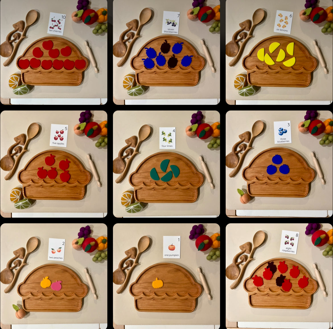 Nine wooden cupcake-shaped trays each holding different colorful felt fruit pieces with wooden utensils and felt vegetables nearby