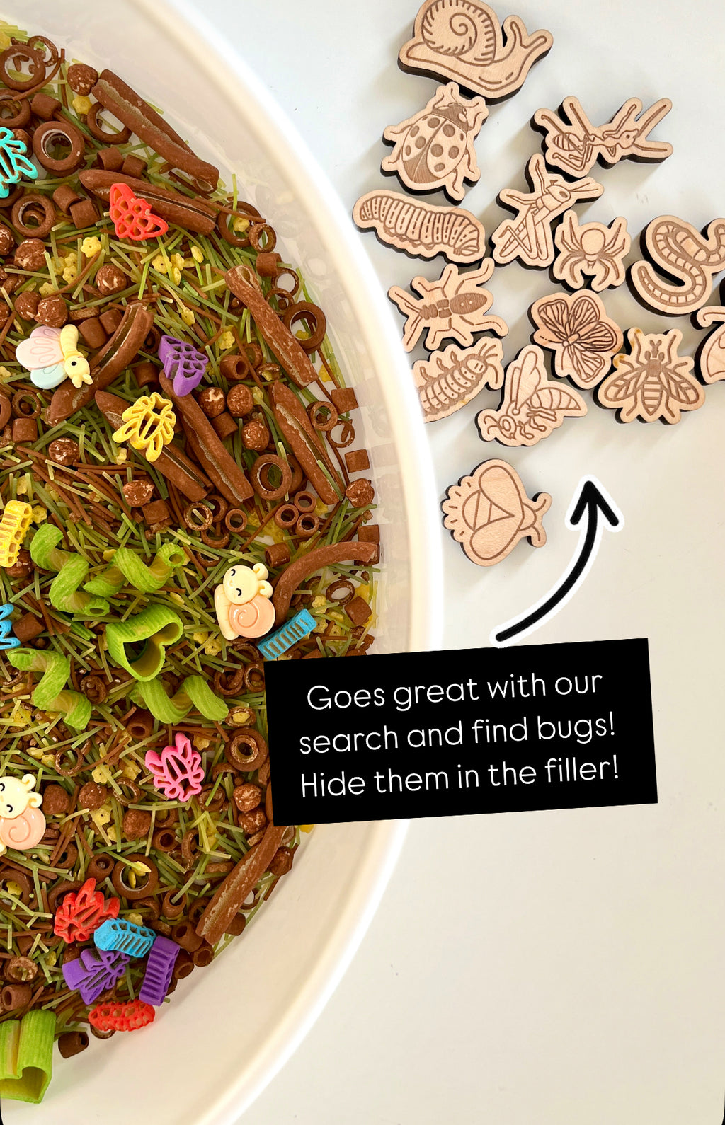 Plastic and wooden insect shapes scattered beside a bowl filled with textured grass and pasta mix on white surface