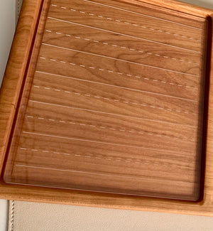 Clear acrylic handwriting practice board with dashed and solid guide lines on wooden frame background