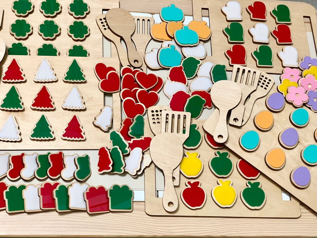 Wooden cookie sheet and colorful wooden cookies with attached hook and loop on light wood table