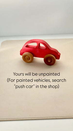 Small red wooden toy car with natural wooden wheels displayed on a neutral background with text below it