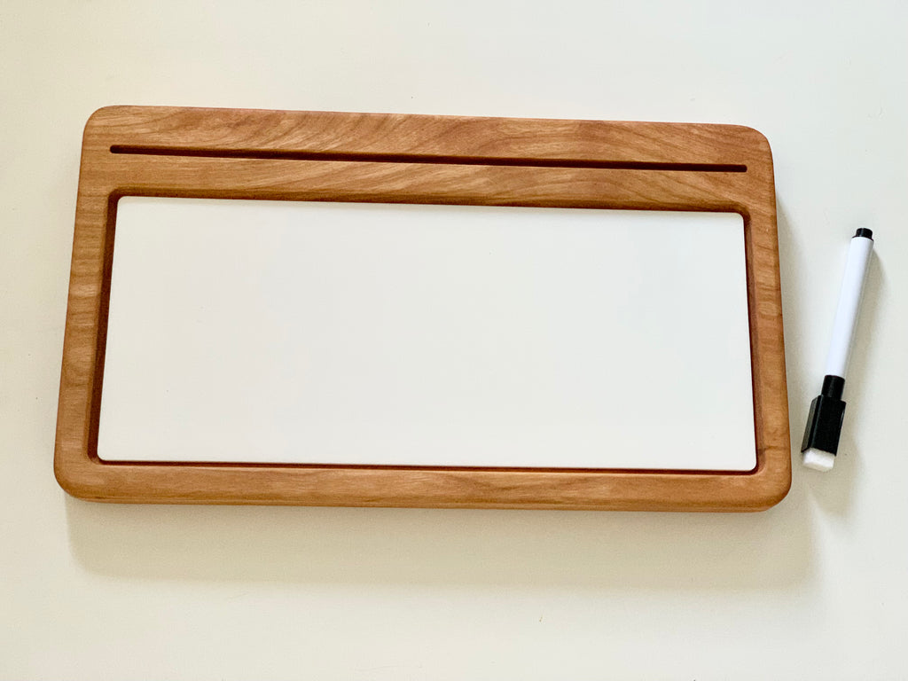 Rectangular wooden writing tray with white dry erase board and black marker on light background