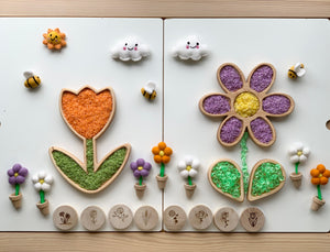 Wooden flower trays filled with colorful textured materials surrounded by felt flower pots and smiling felt clouds with bees and sun