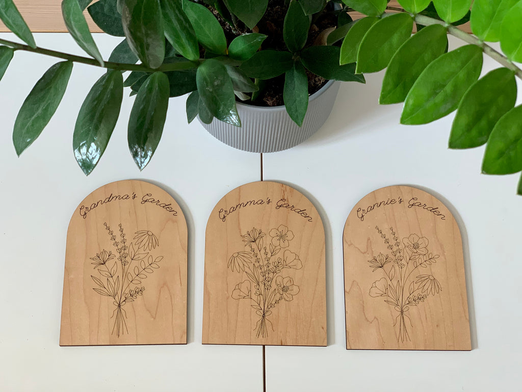 Set of three wooden garden plaques engraved with floral birth month designs and personalized Grandma's Garden text