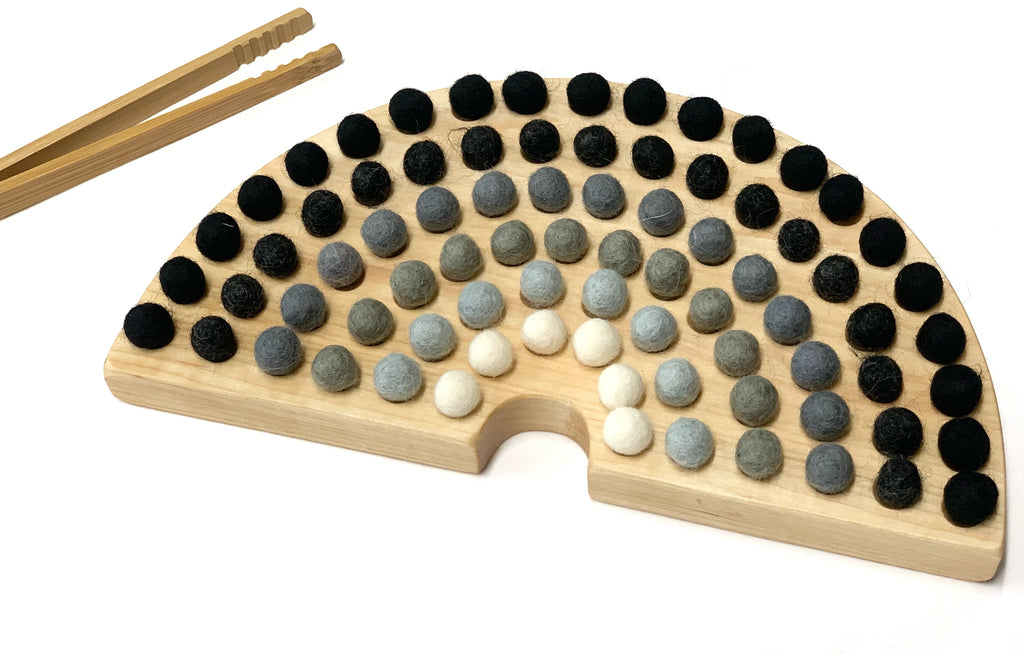 Canadian Cherry Hardwood rainbow sorting board with smooth engraved holes and felt balls in neutral tones with wooden tweezers