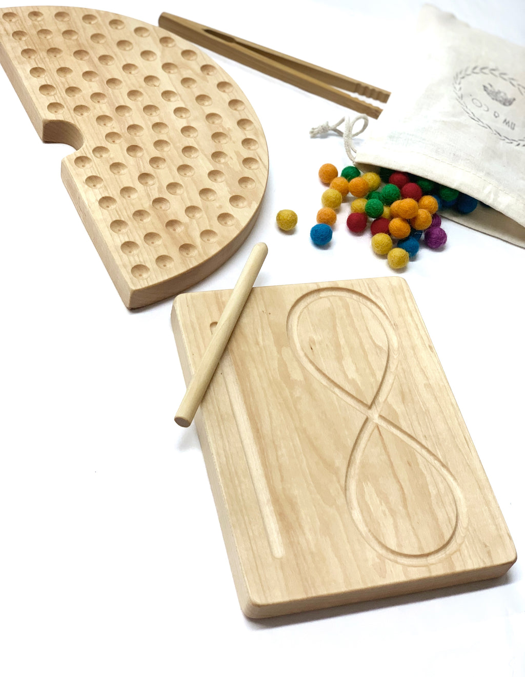 Natural maple wooden figure eight tracing board with stylus, pegboard, tweezers, and colorful felt balls on white background